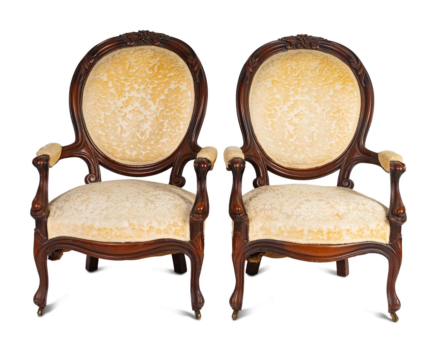 A Pair of Rococo Revival Carved Walnut Fauteuils
