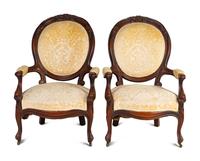 A Pair of Rococo Revival Carved Walnut Fauteuils