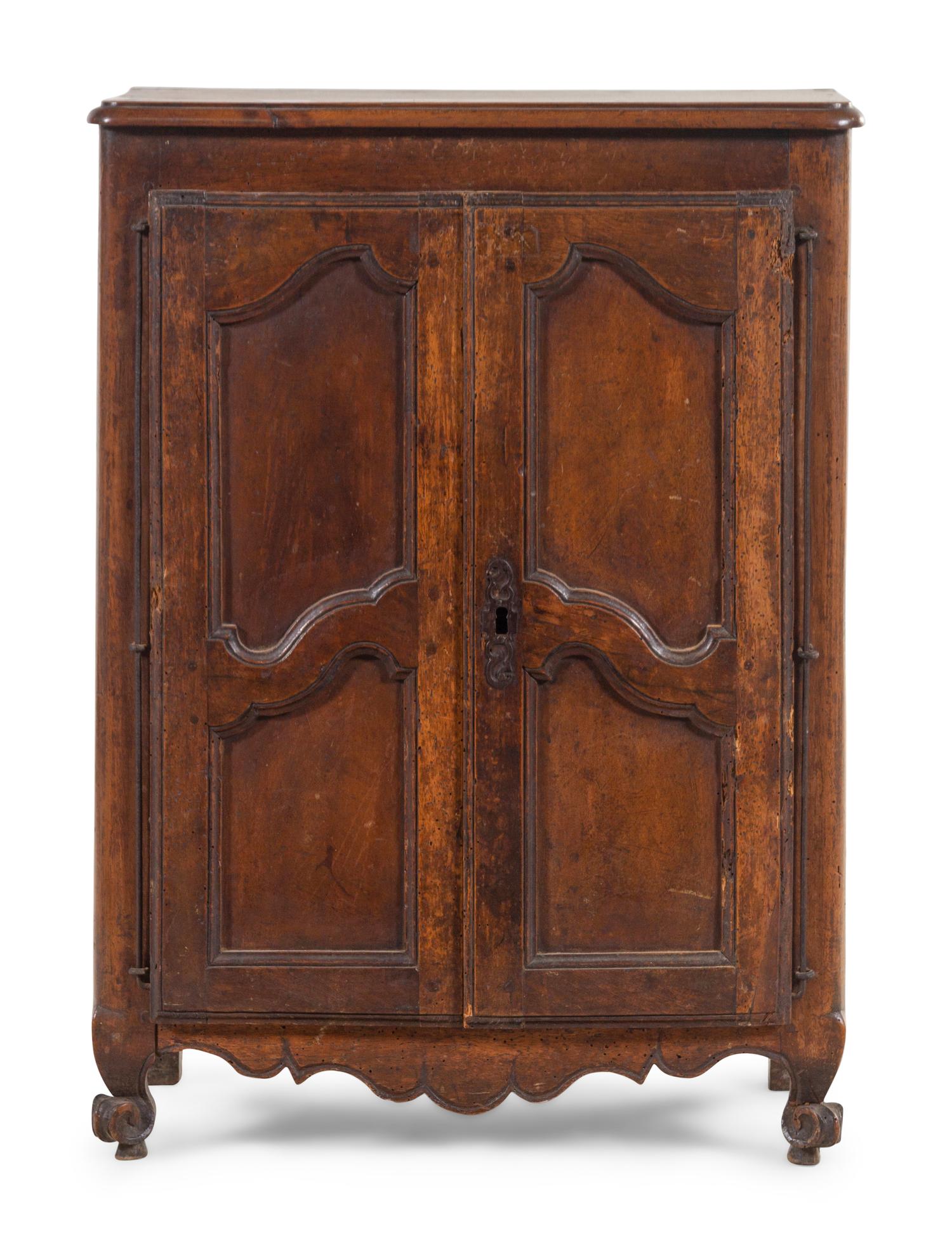 A French Provincial Carved Walnut Diminutive Armoire