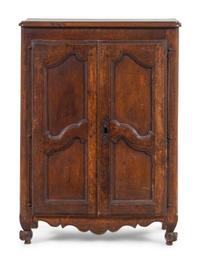 A French Provincial Carved Walnut Diminutive Armoire