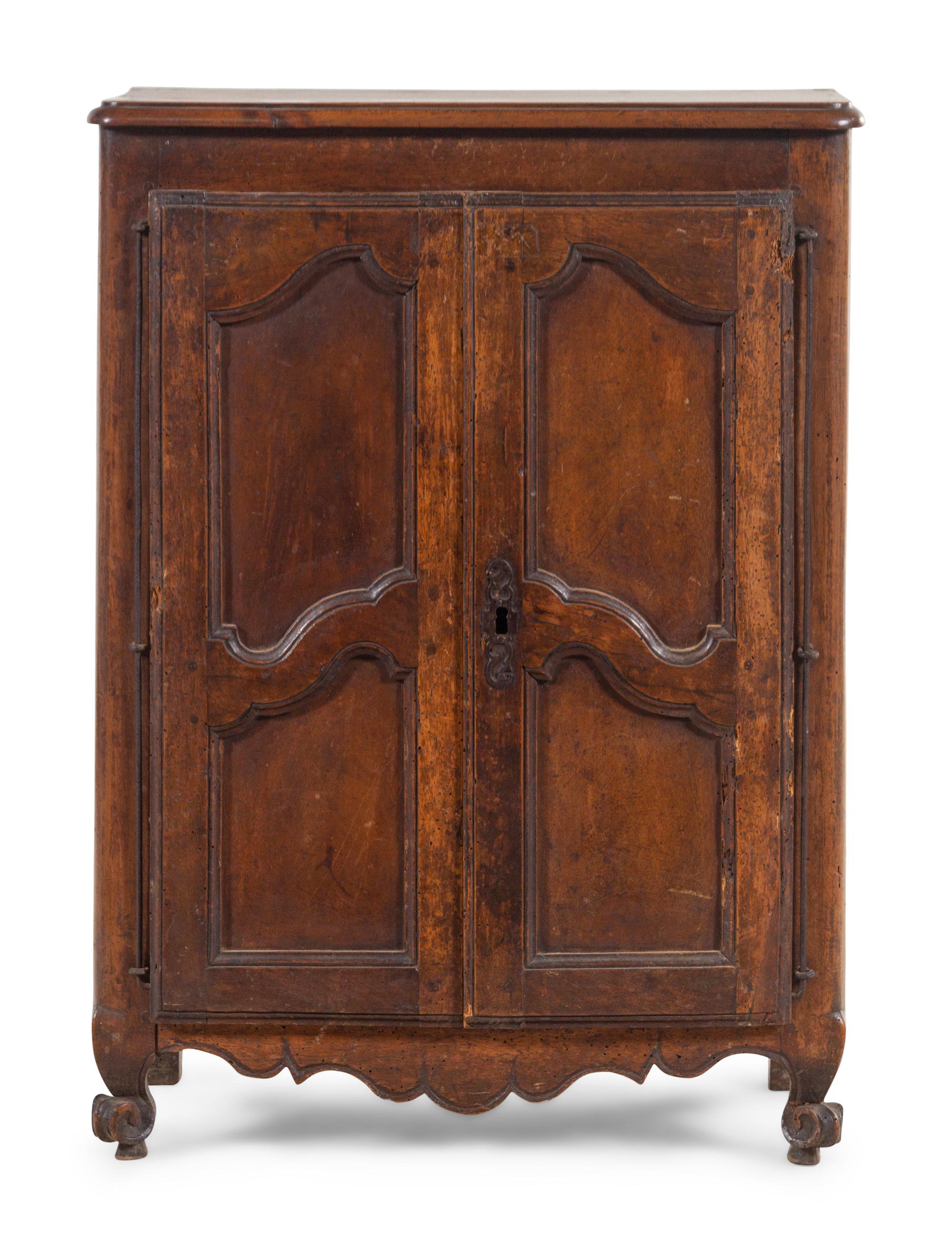 A French Provincial Carved Walnut Diminutive Armoire