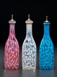 Three Coral Opalescent Glass Barber's Bottles