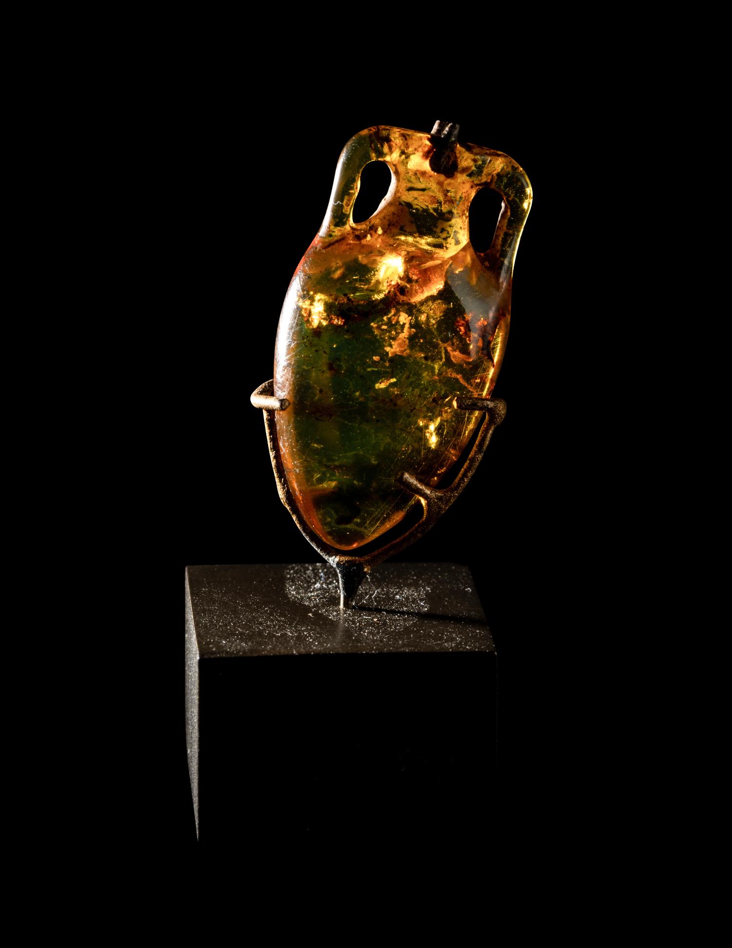 A Roman Natural Amber Amphoriskos Pendant