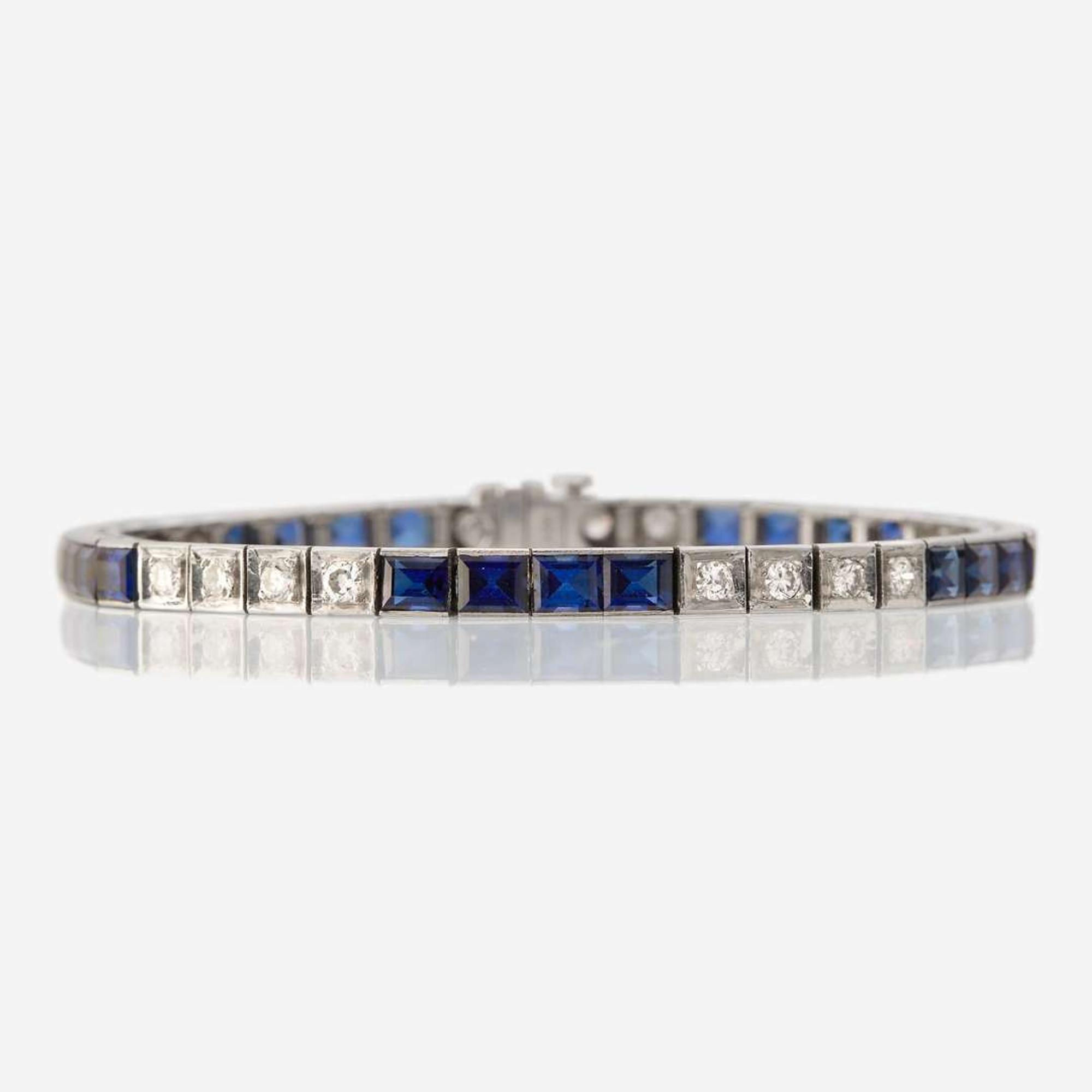 A fourteen karat white gold, synthetic sapphire, and diamond bracelet