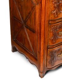A Louis XV Provincial Carved Walnut Commode