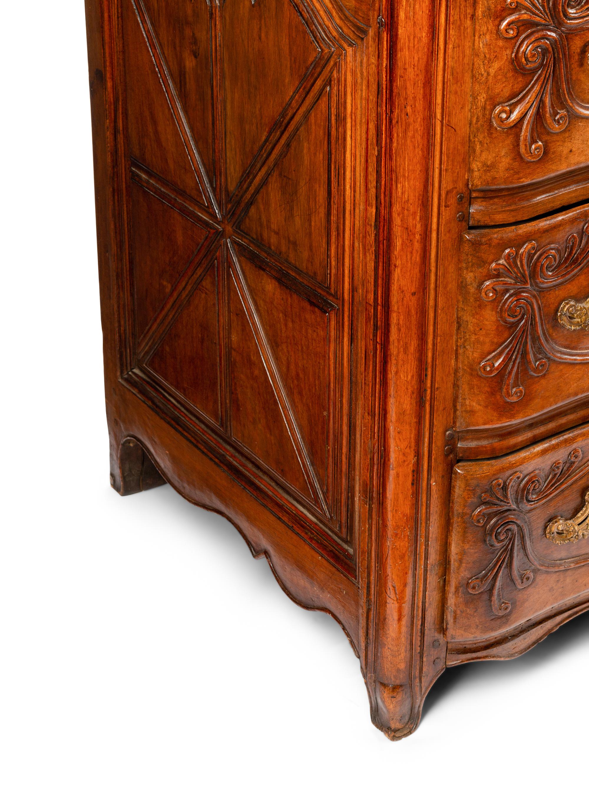 A Louis XV Provincial Carved Walnut Commode