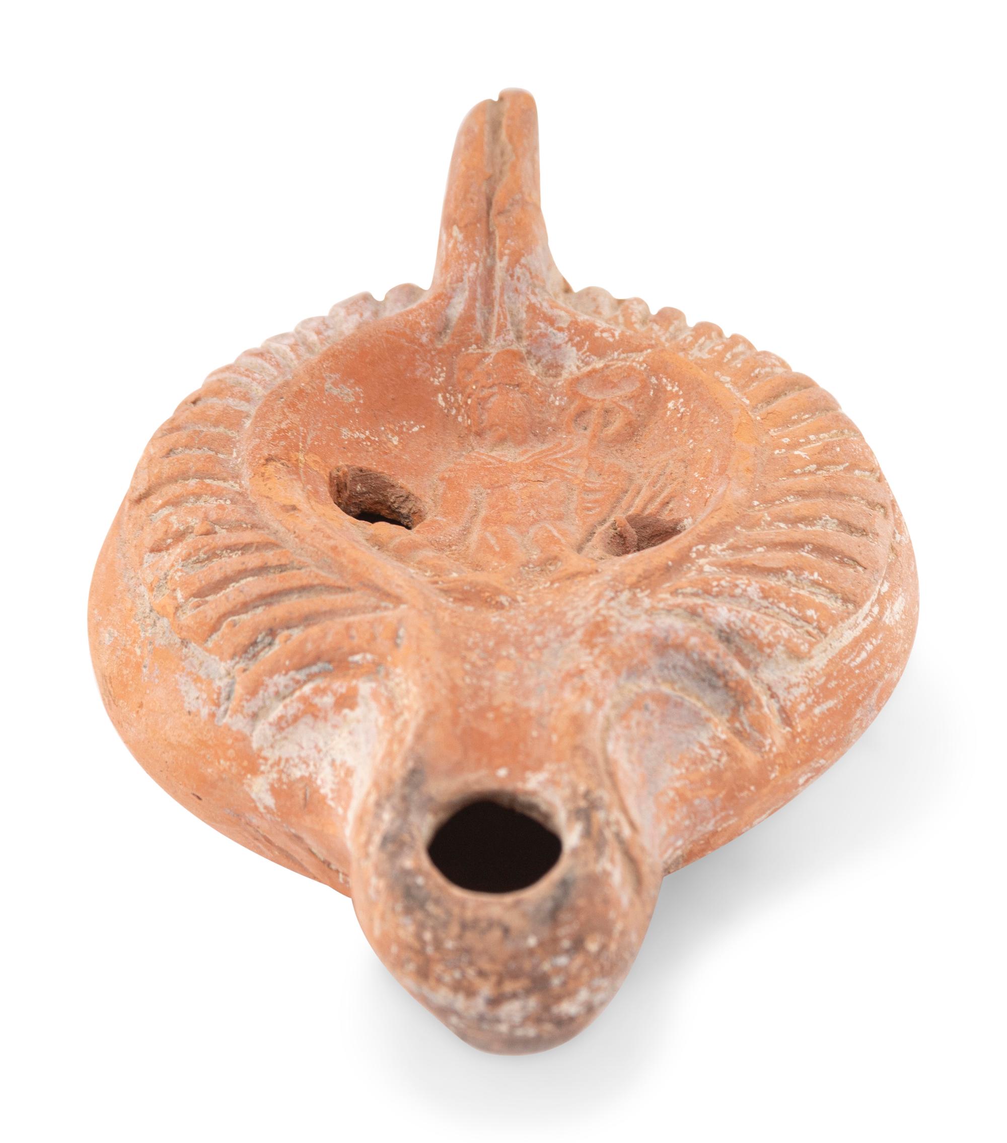 A Roman Terracotta Discus Lamp Depicting the God Hermes