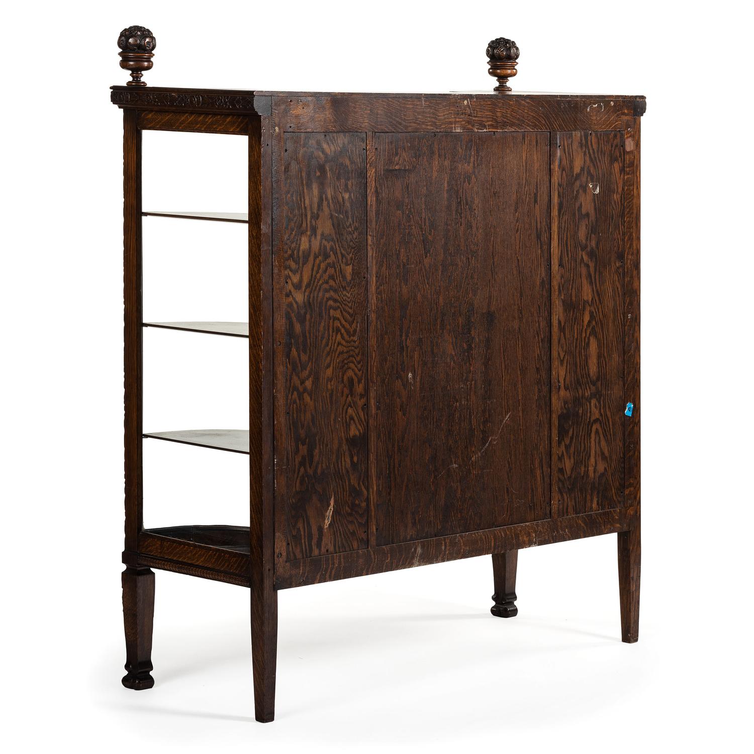 A Carved Oak Vitrine Cabinet and Open Bookshelf