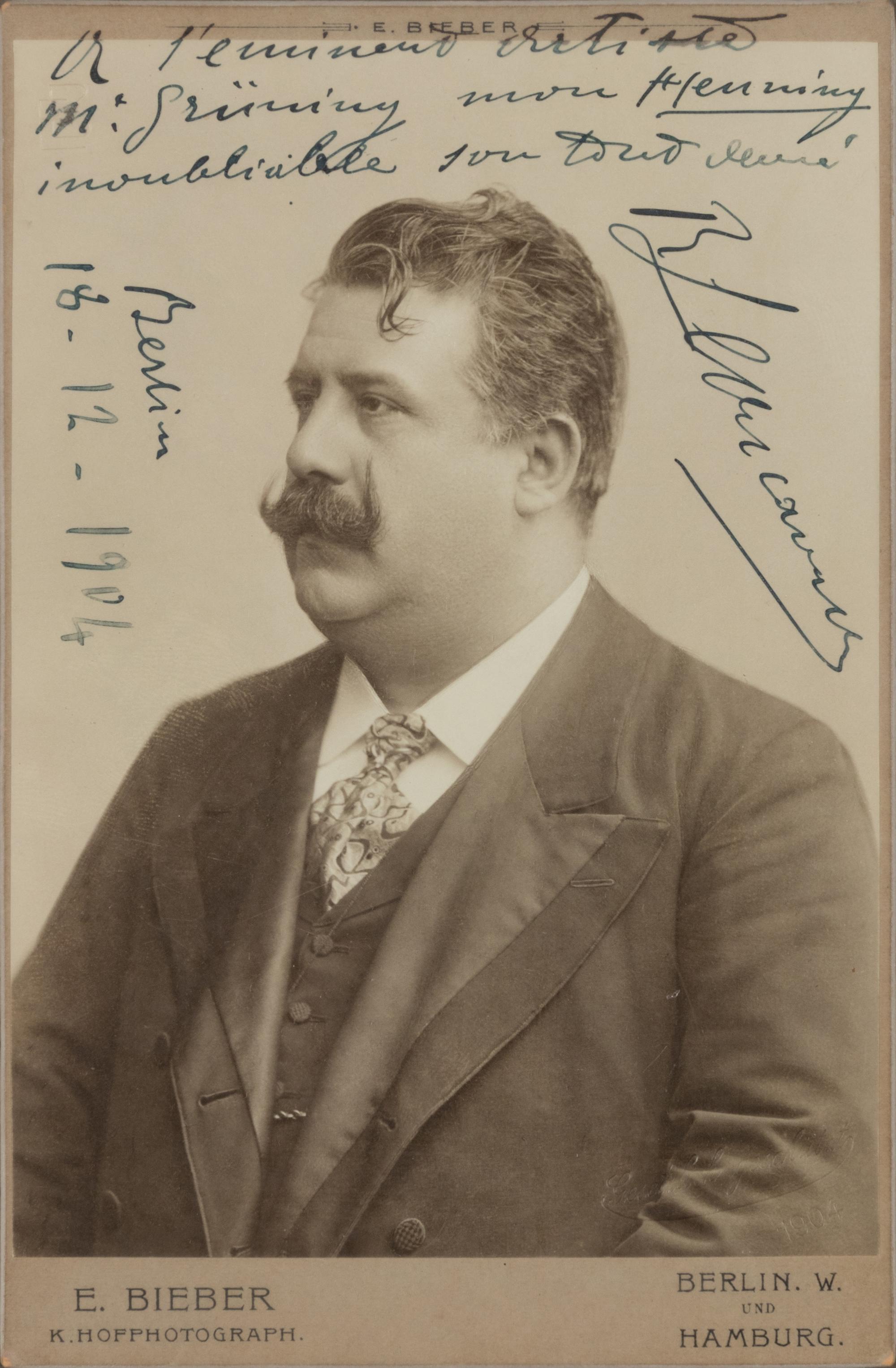 LEONCAVALLO, Ruggiero (1857-1919). Black and white photographic portrait, signed (“R. Leoncavallo”) and additionally inscribed, Berlin, 18 December 1904.