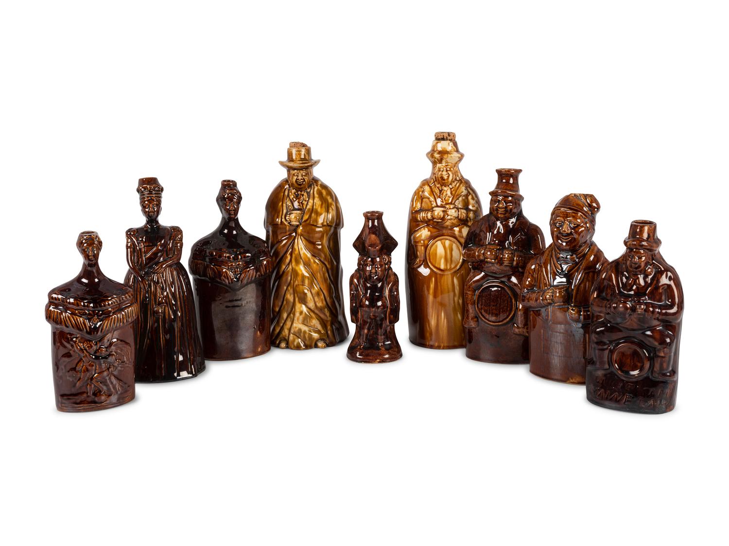 Nine Figural Flasks in Brown Glaze