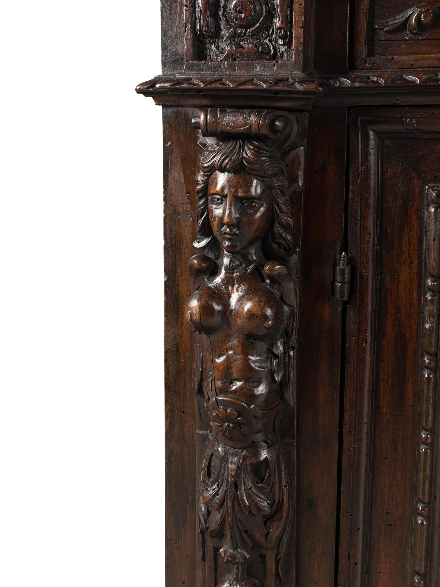 An Italian Baroque Carved Walnut Cabinet