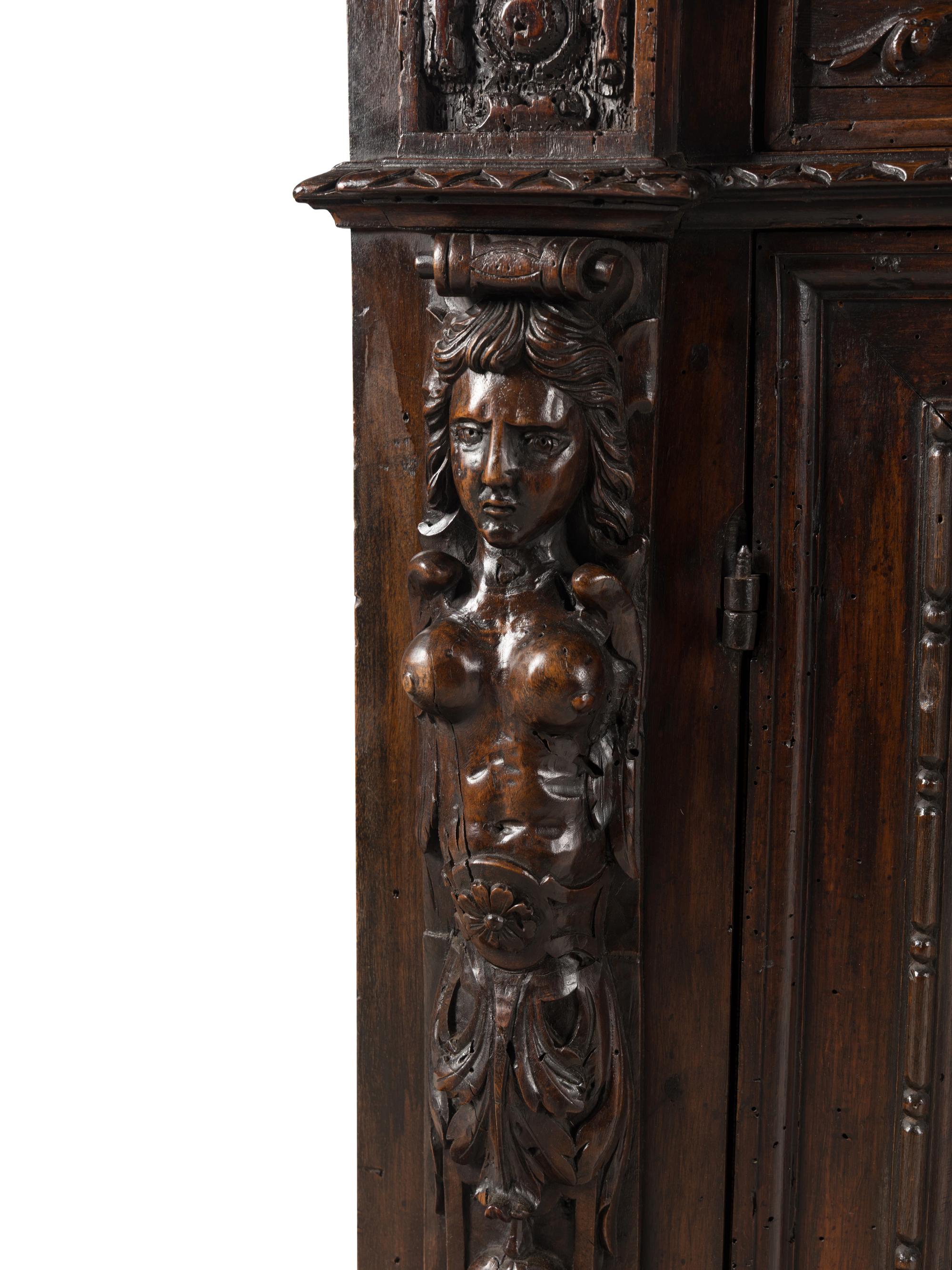 An Italian Baroque Carved Walnut Cabinet