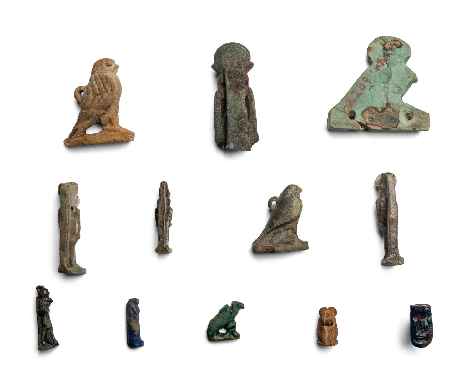 Twelve Egyptian Faience and Stone Horus Amulets