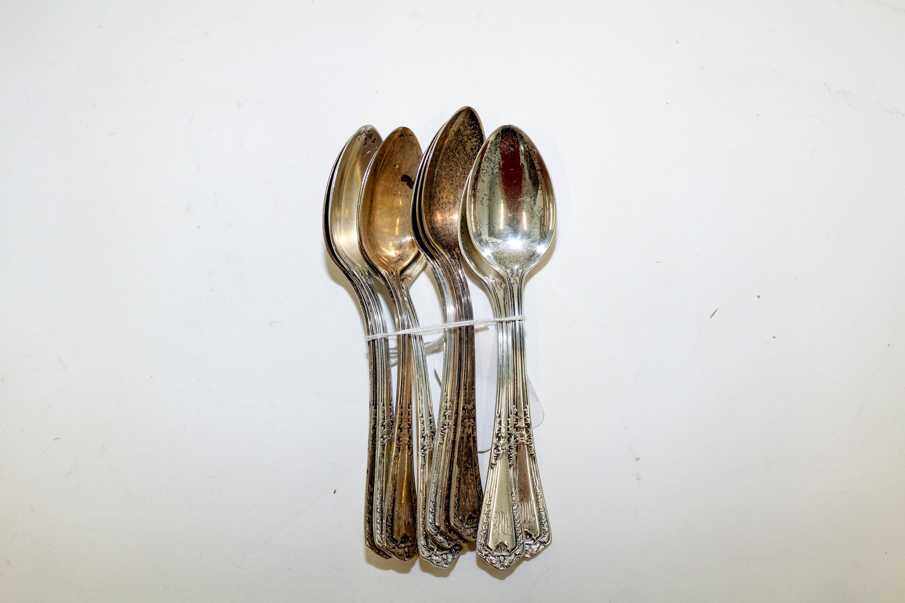 A Set of Nine American Silver Teaspoons, Reed & Barton, Taunton, MA, the handle decorated with floral and vine elements in the Art Nouv