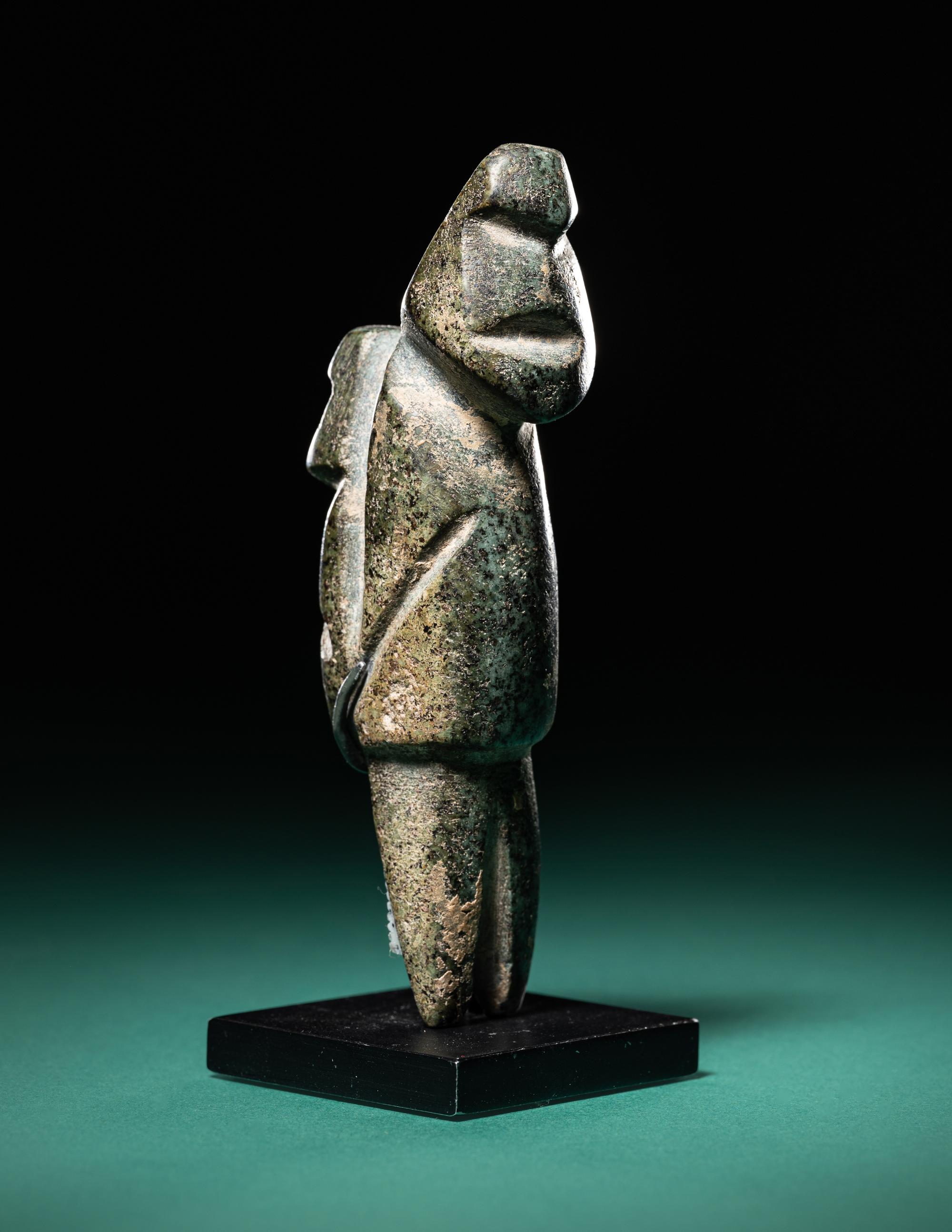 A Mezcala Diorite Standing Figure with an Infant