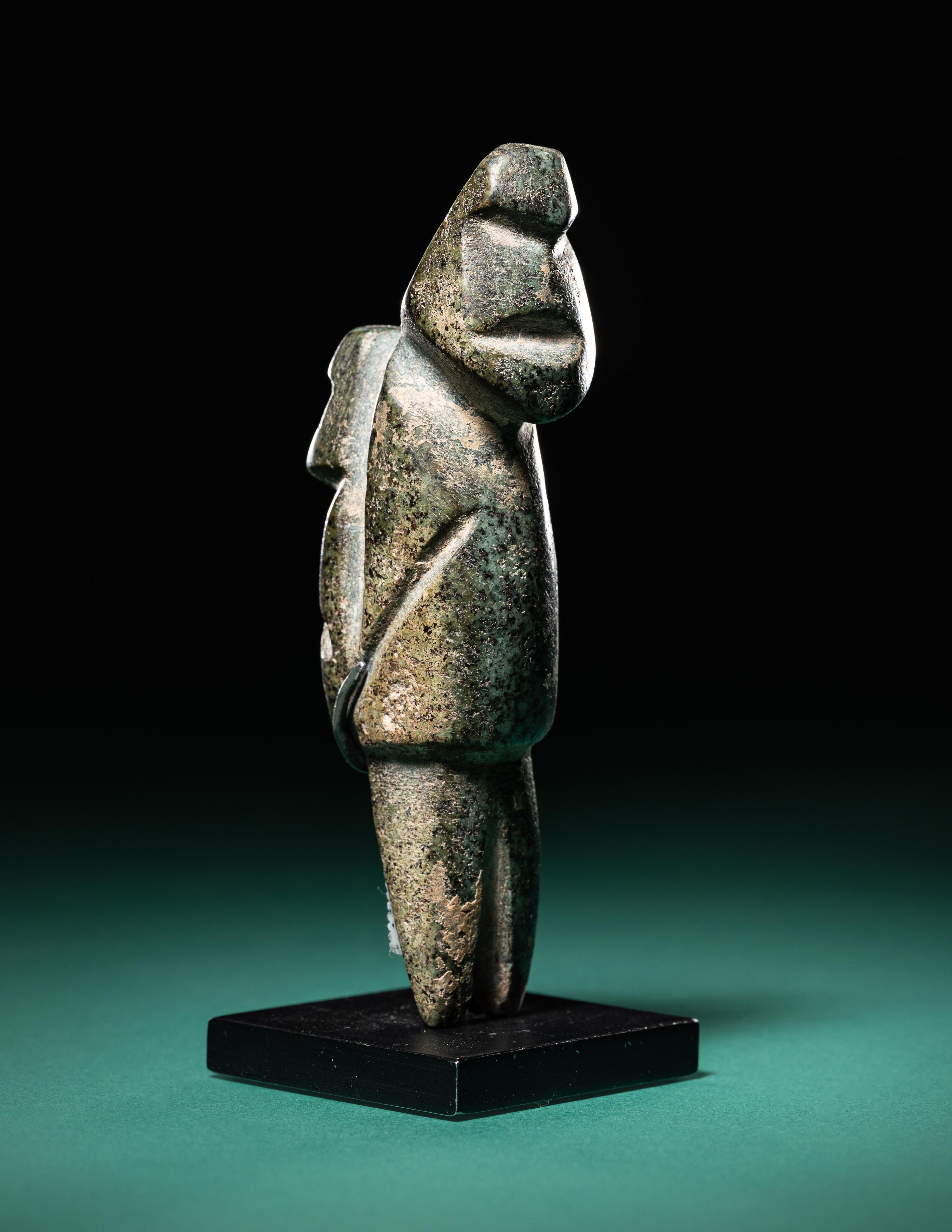 A Mezcala Diorite Standing Figure with an Infant
