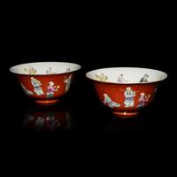 A Pair of Chinese Coral-Red Ground Famille Rose Porcelain Bowls, Late 19th-20th Century — 清晚期 珊瑚紅地粉彩童子圖碗一對