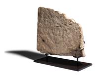 An Egyptian Limestone Relief Fragment with Serving Woman