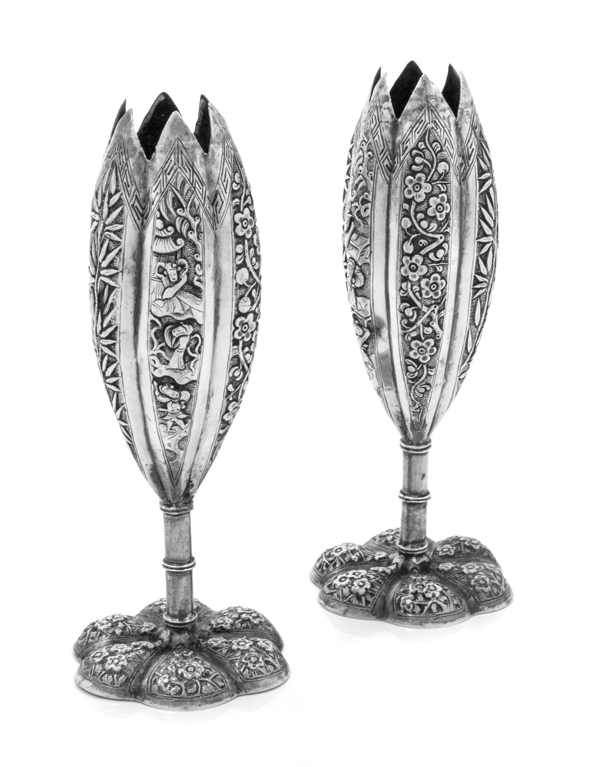 A Pair of Chinese Silver Candle Holders, Maker's Marks Obscured, each having a floriform body worked to show bamboo and Chinoiserie rep