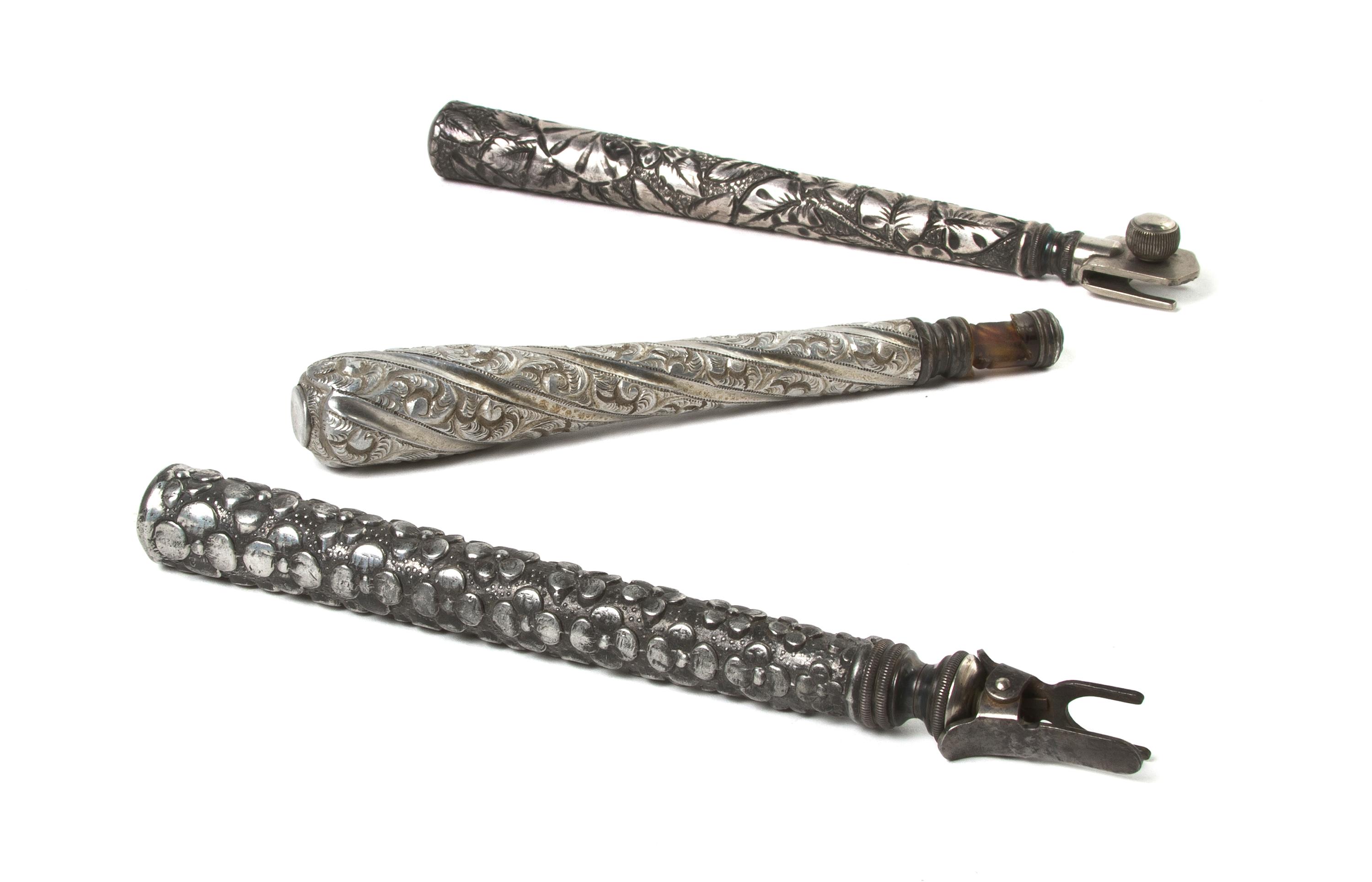 Three Silvered Metal Opera Glass Holders, Length of longest 6 3/4 inches (closed).