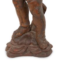 An Italian Carved Walnut Figure of Putto