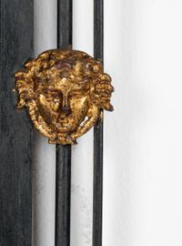 An Empire Style Parcel Gilt Metal Framed Mirror