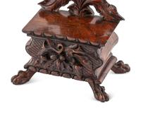 A Black Forest Carved Walnut Stand