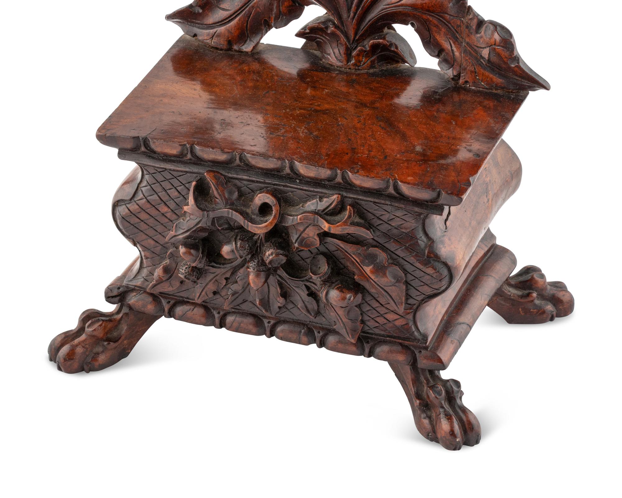 A Black Forest Carved Walnut Stand
