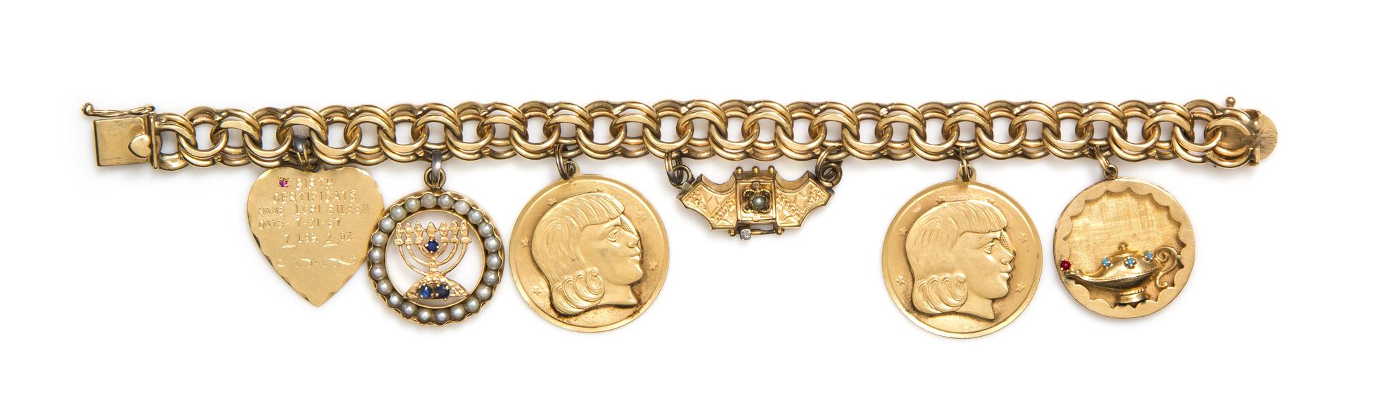 A 14 Karat Yellow Gold Charm Bracelet with Six Attached Charms, 43.80 dwts.