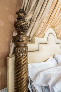An Italian Carved Giltwood Bedstead with Baldachin, Headboard and Drapes