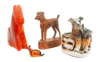A Group of Four Airedale Terrier Figures Height of tallest 7 1/4 inches.