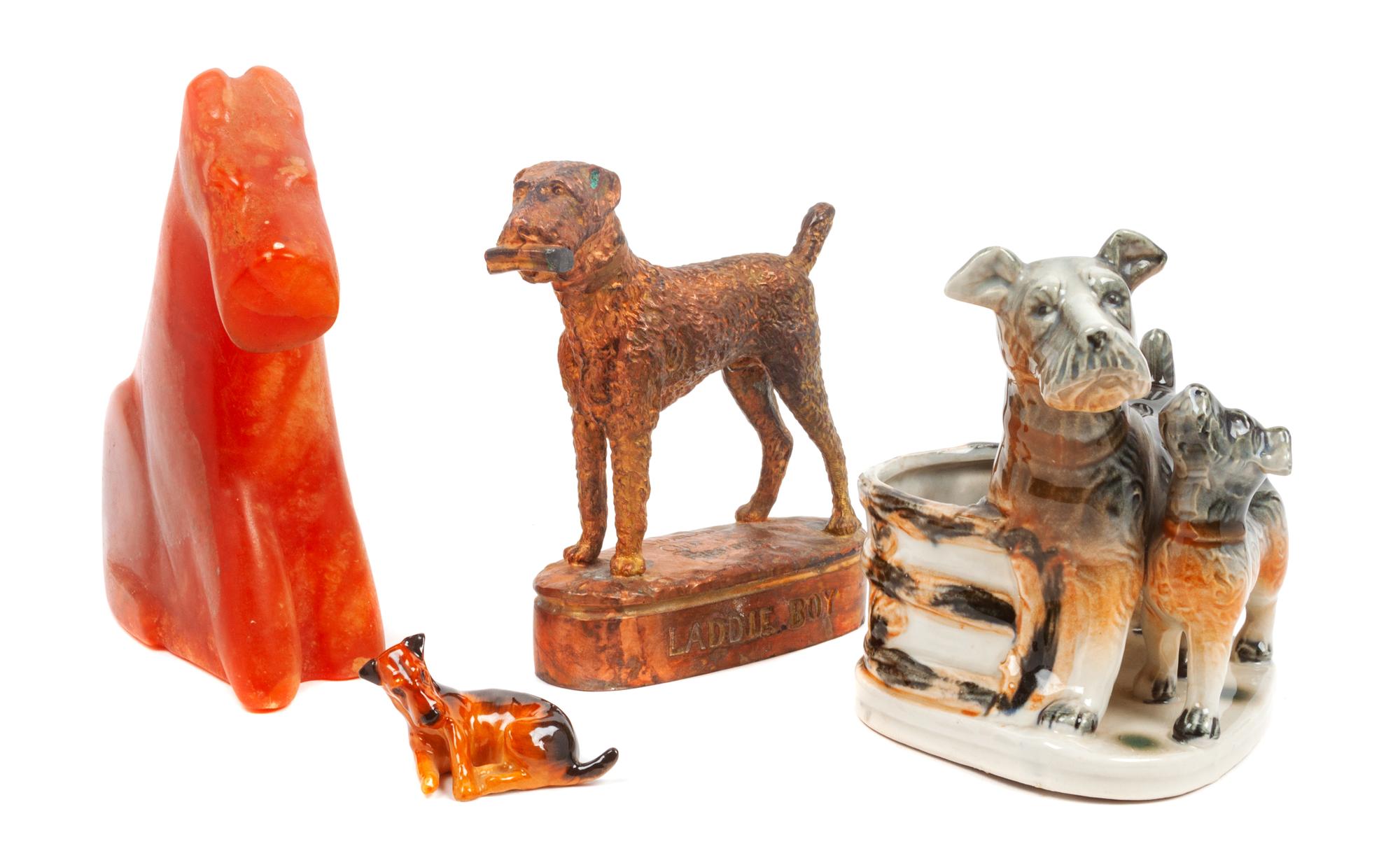 A Group of Four Airedale Terrier Figures Height of tallest 7 1/4 inches.