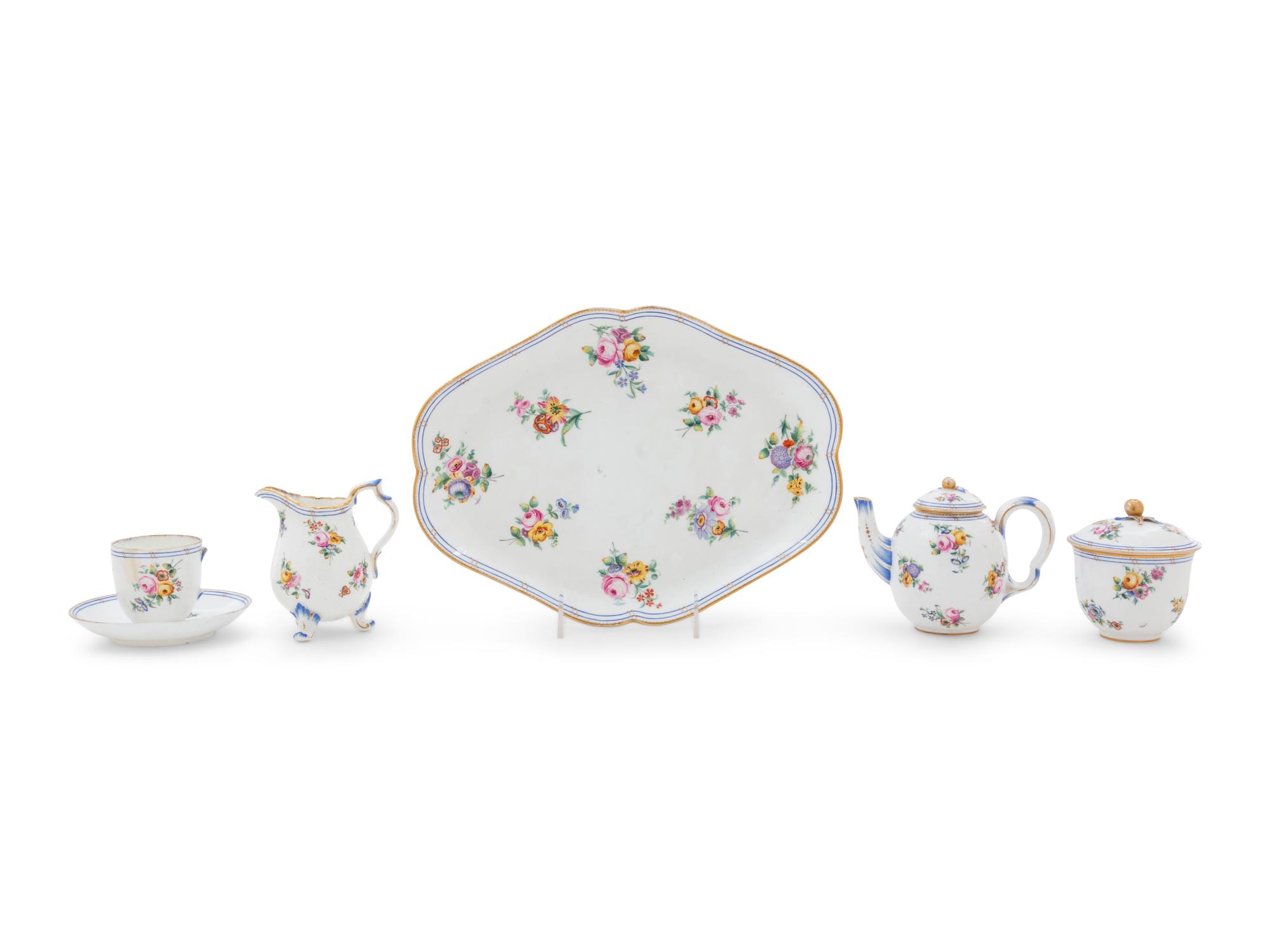 A Sèvres Painted and Parcel Gilt Porcelain Tea Service in a Mahogany and Marquetry Fitted Traveling Case