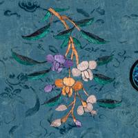 Two Chinese Embroidered Silk Lady's Robes, 19th Century 清晚期 藍地織錦綉花女上衣兩件