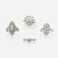 A collection of four white gold and diamond rings
