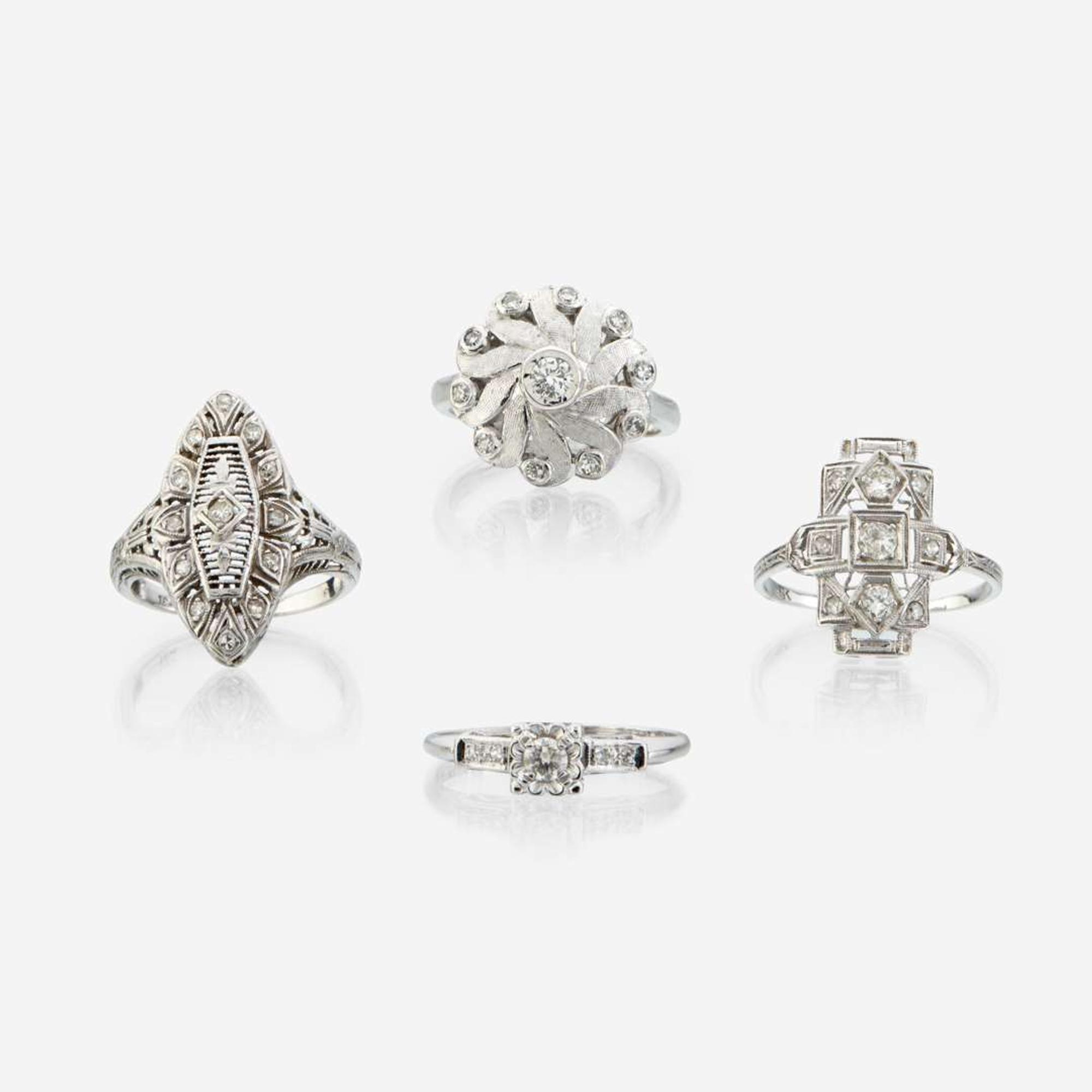 A collection of four white gold and diamond rings