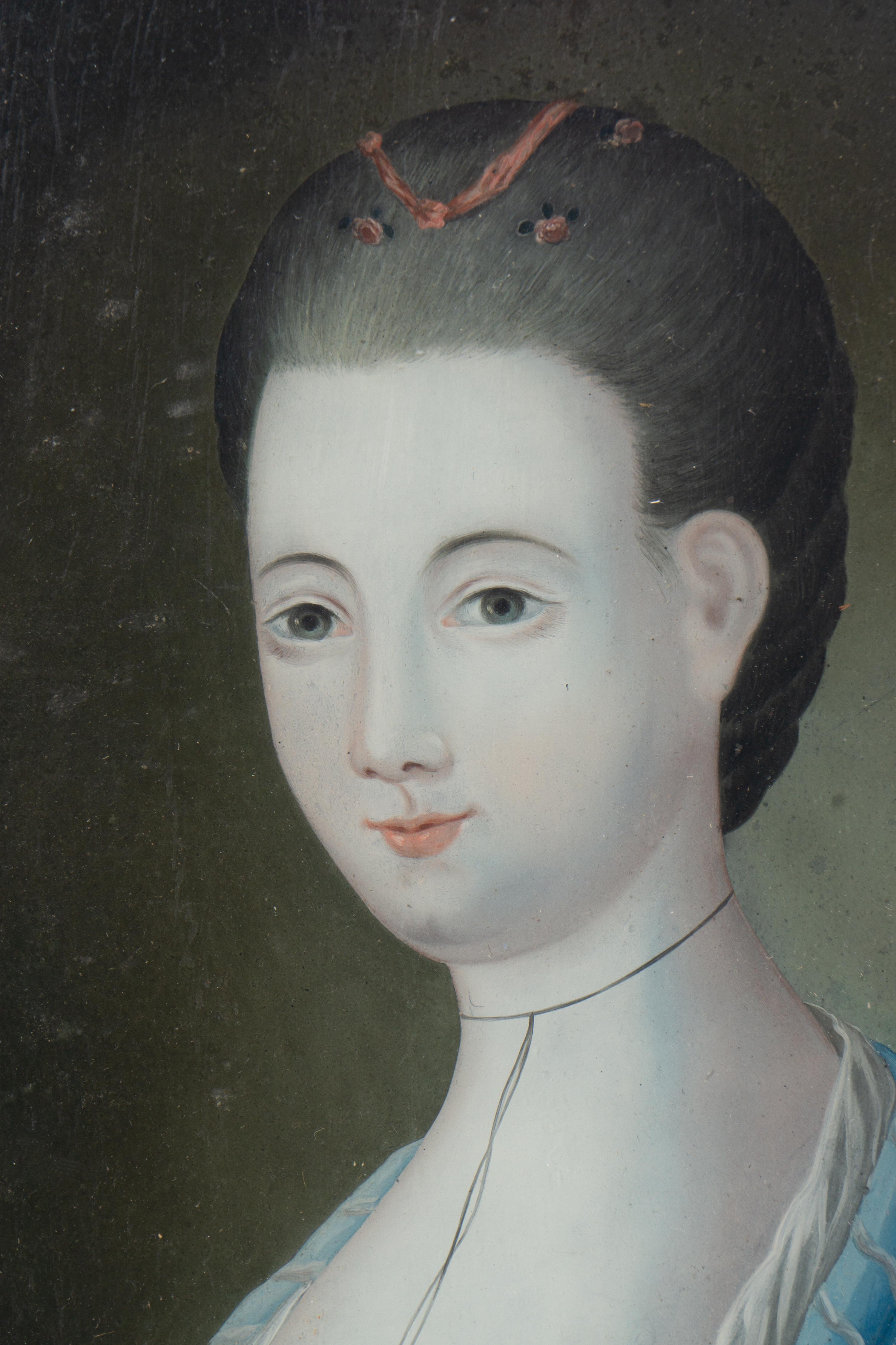 A Pair of English Reverse-Painted Glass Portraits