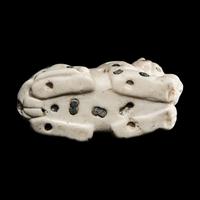 A Mesopotamian Marble and Lapis Lazuli Recumbent Leopard