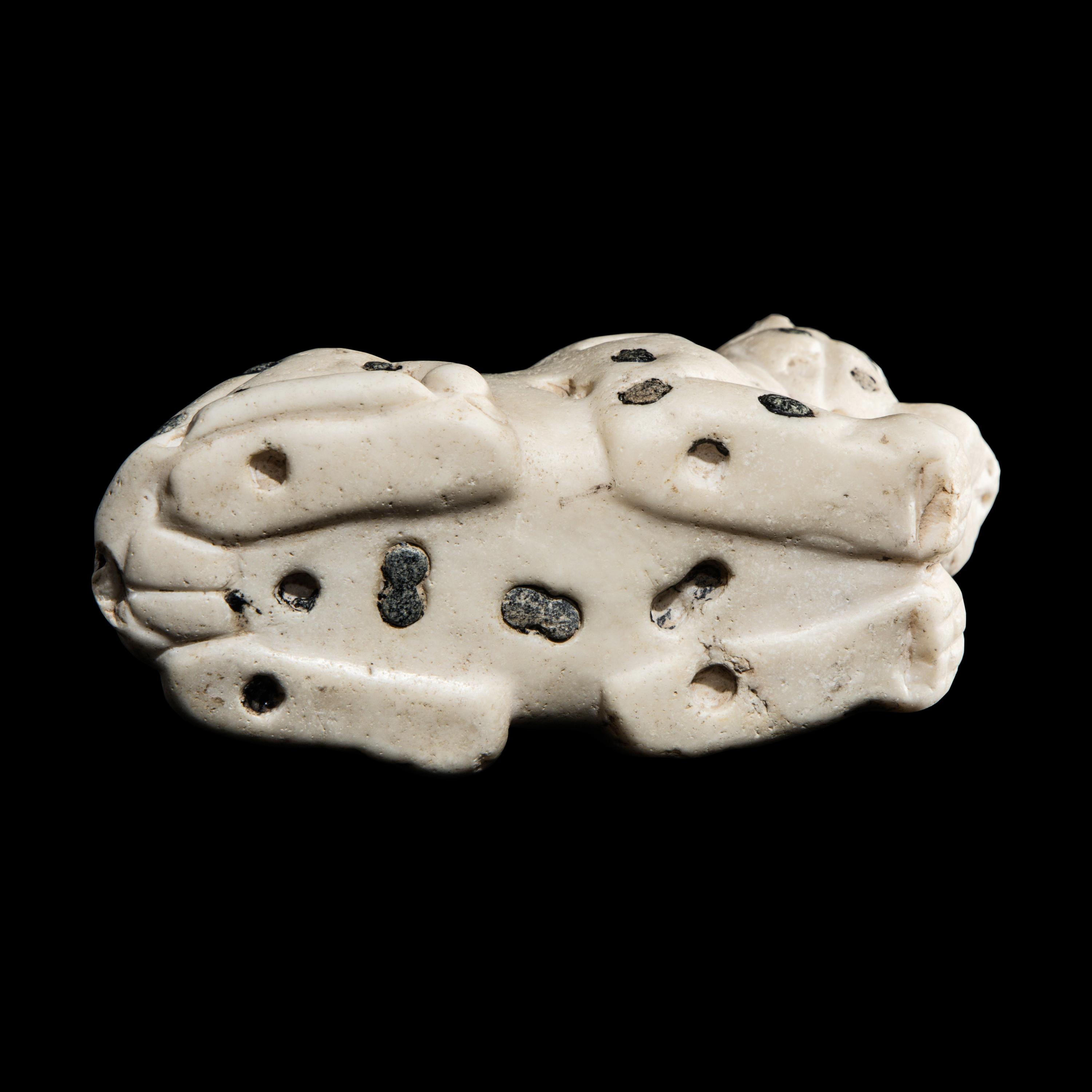 A Mesopotamian Marble and Lapis Lazuli Recumbent Leopard