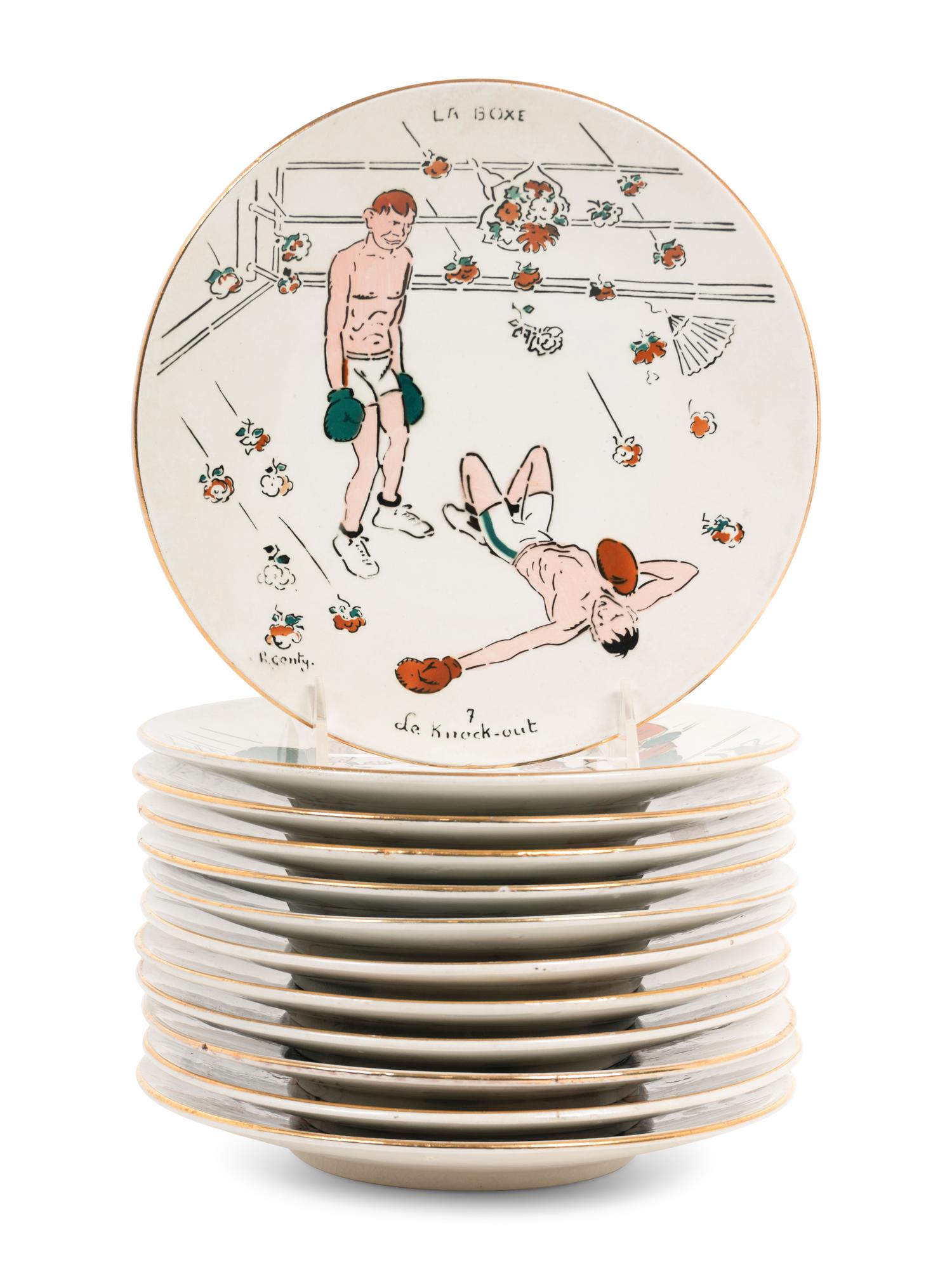 A Set of Twelve Le Boxe Decorative Plates Featuring Boxing Scenes by C. R. Genty,