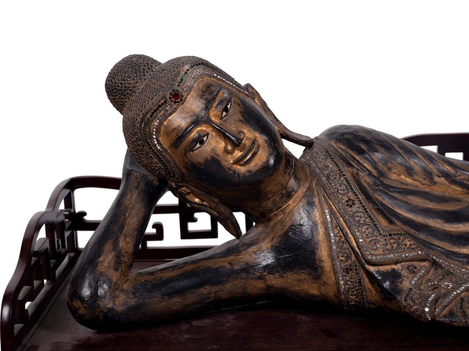 A Thai Gilt Decorated Black Lacquered Wood Figure of Reclining Buddha