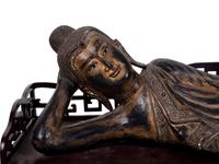A Thai Gilt Decorated Black Lacquered Wood Figure of Reclining Buddha