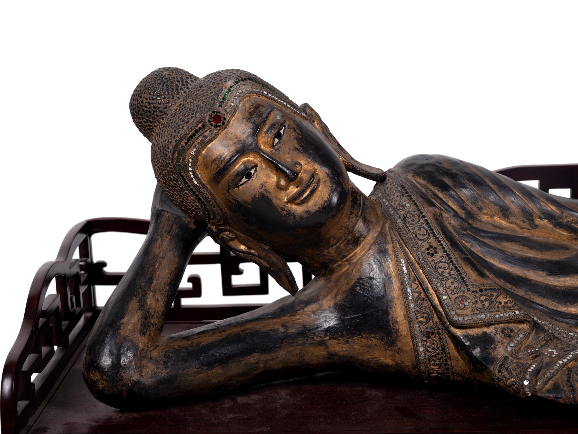 A Thai Gilt Decorated Black Lacquered Wood Figure of Reclining Buddha