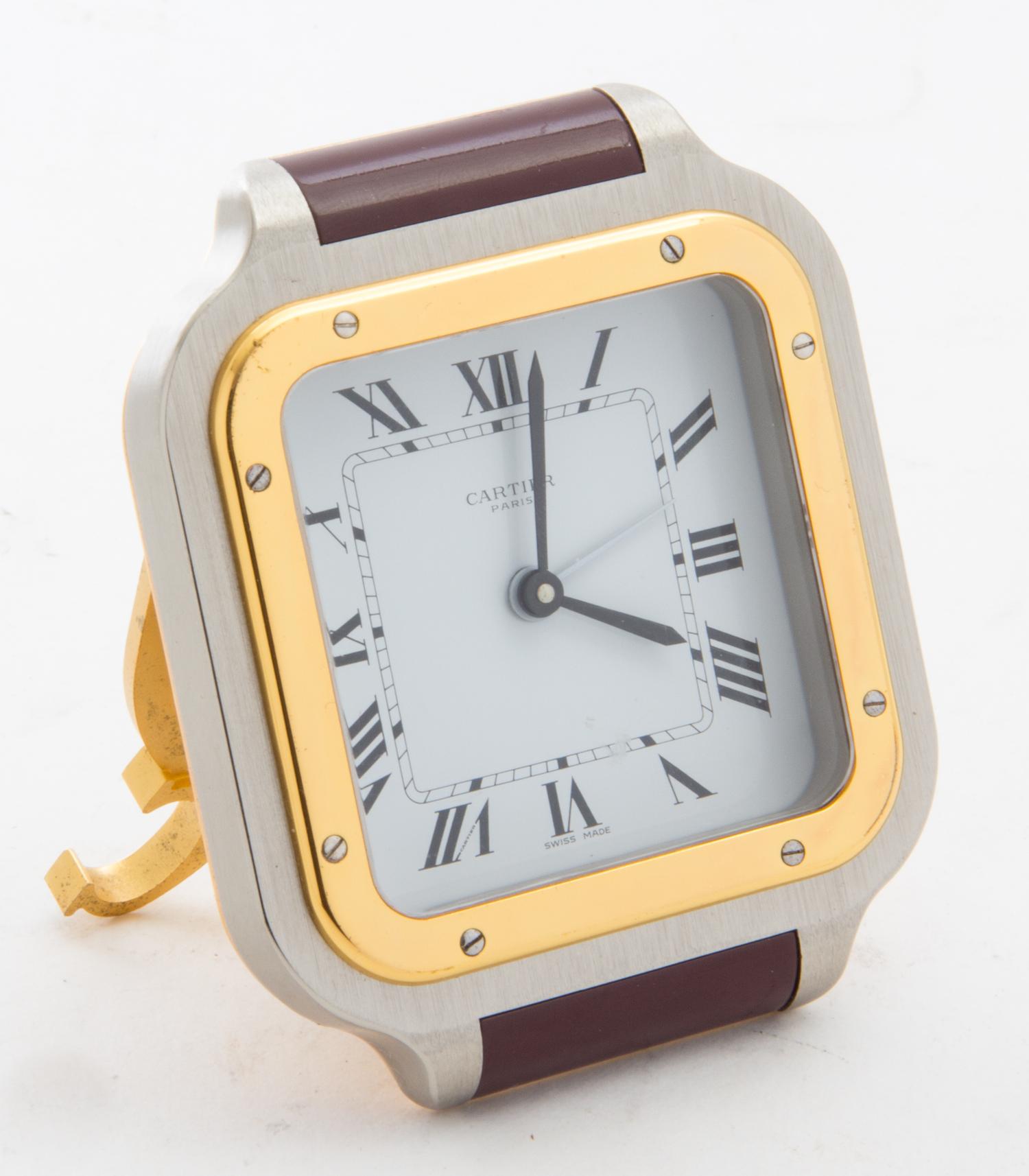 A Cartier Stainless Steel, Gold Tone and Enamel Santos Travel Clock Width of clock 2 7/8 inches.