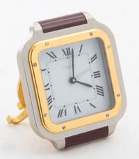 A Cartier Stainless Steel, Gold Tone and Enamel Santos Travel Clock Width of clock 2 7/8 inches.