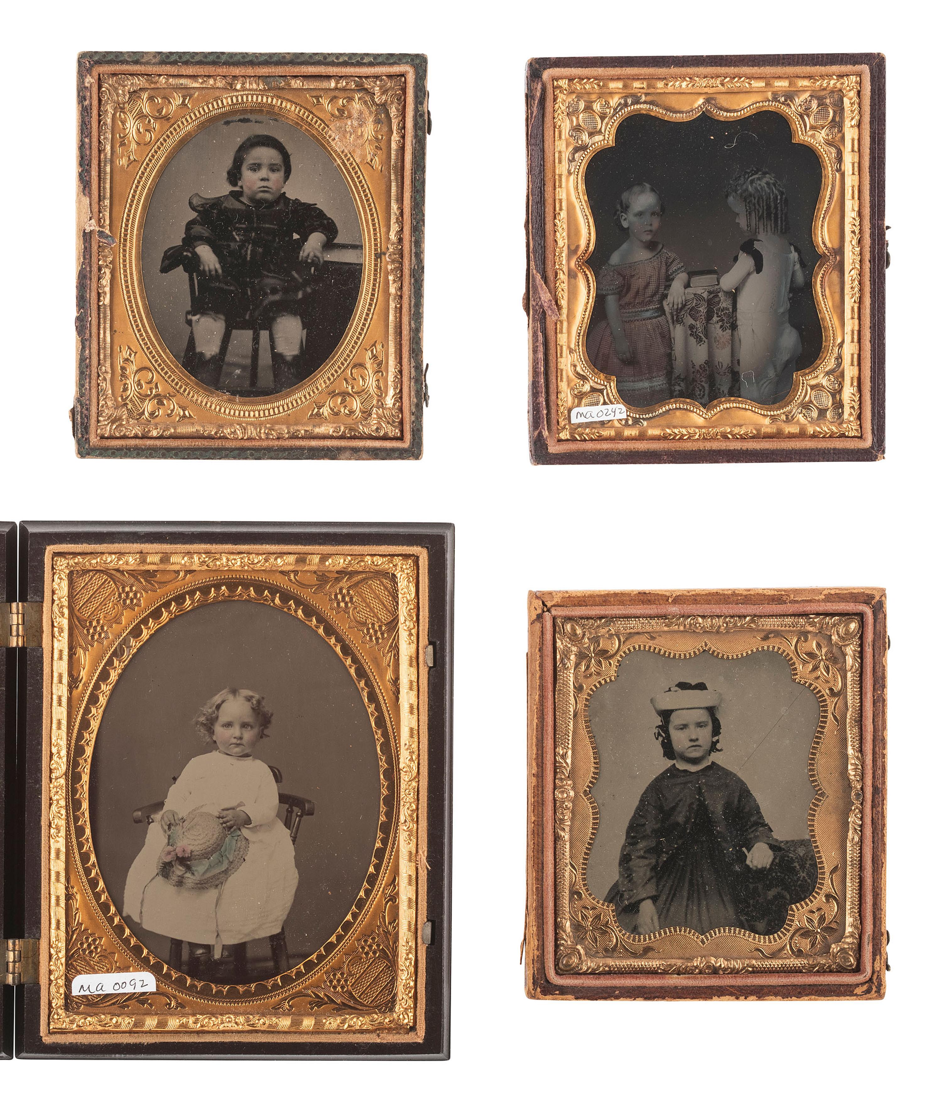 [EARLY PHOTOGRAPHY]. 18 ambrotypes and tintypes of children, many featuring fine hand tinting.