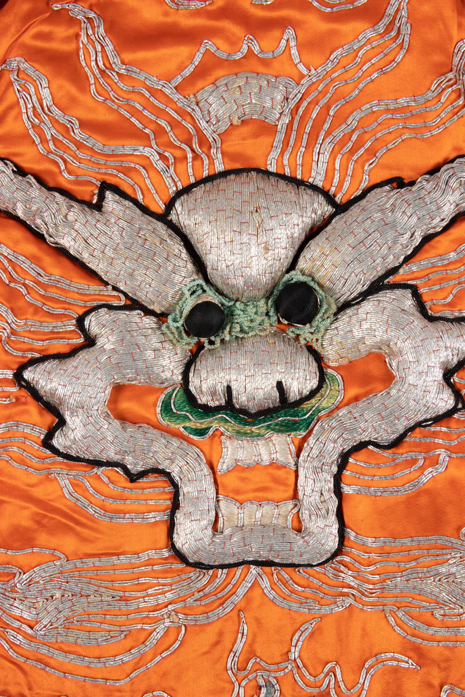 Two Chinese Orange Ground Embroidered Silk Theatrical Robes and A Cape