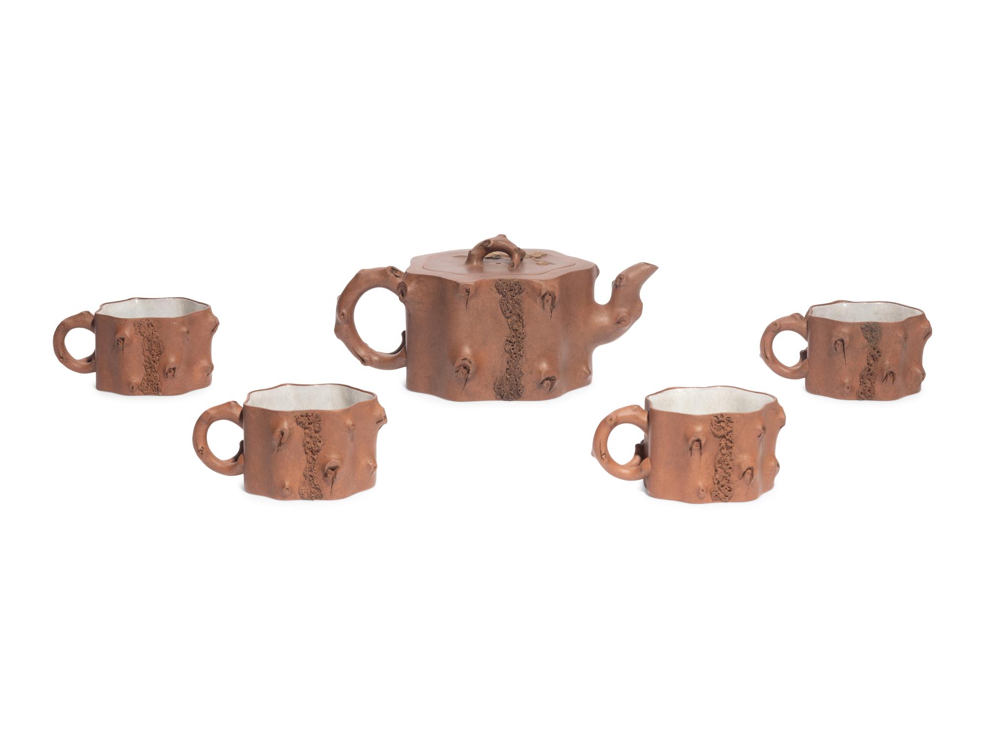 A Chinese Yixing Zisha Pottery Teapot and Four Teacups