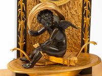 A Louis Philippe Gilt and Patinated Bronze Mantel Clock