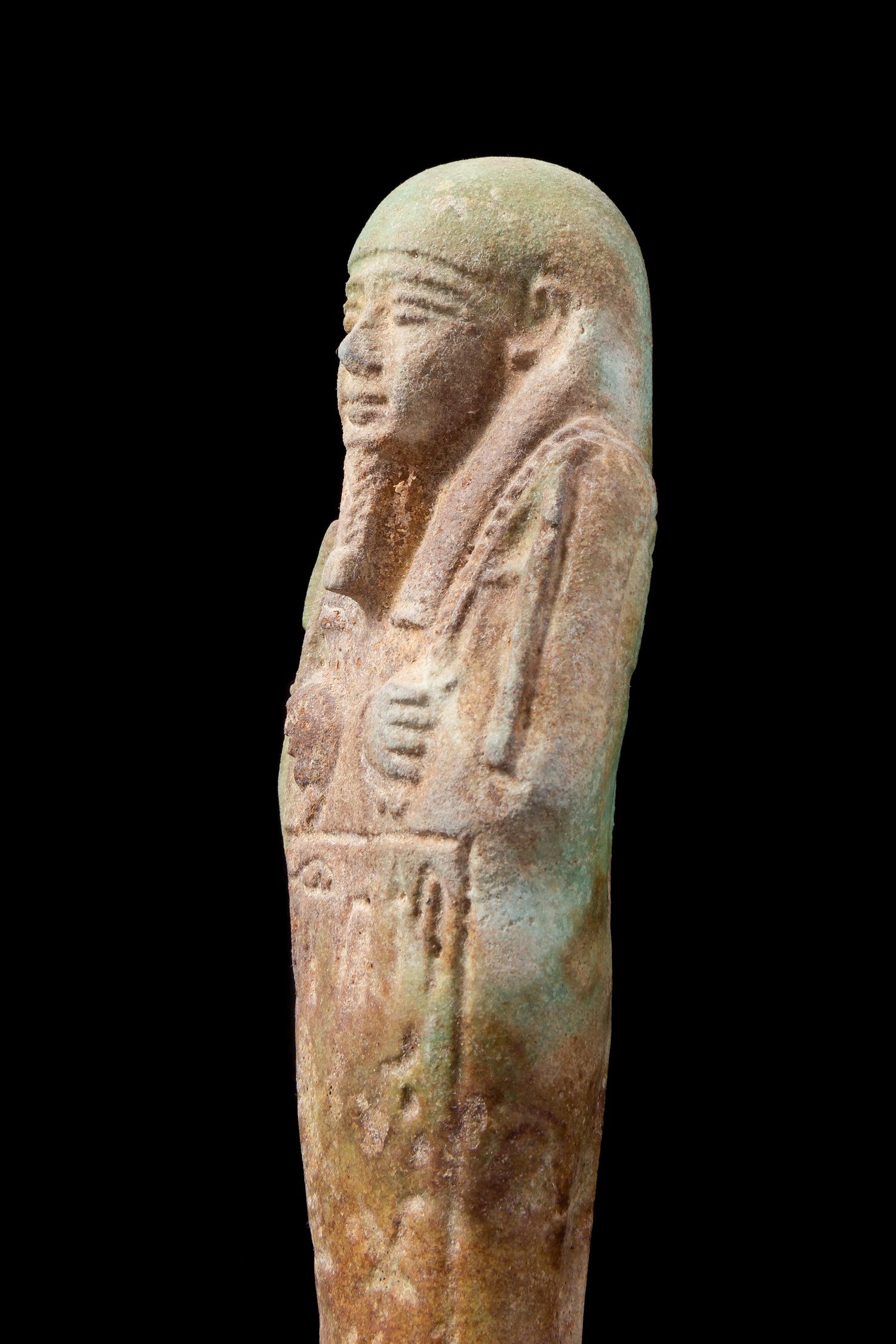 An Egyptian Faience Shabti Height 7 1/2 inches. — LATE PERIOD, DYNASTY 26, 664-525 B.C.E.